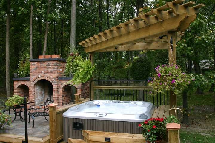 hot tub decor ideas with hot tub in backyard covered with pergola and surrounded by plants