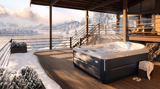 Jacuzzi hot tub on a deck in winter with the Rockies in the background. - hot tub technicians